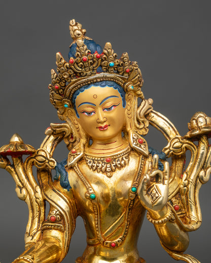 Close up Green Tara face gold-painted with five-jeweled crown, handmade Nepal Buddhist art