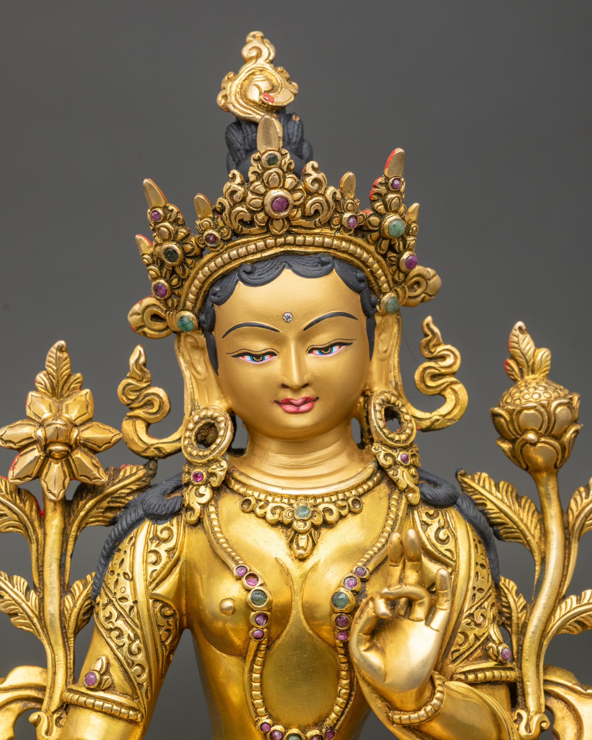 Close up Green Tara face gold gilded finish with semi-precious stones