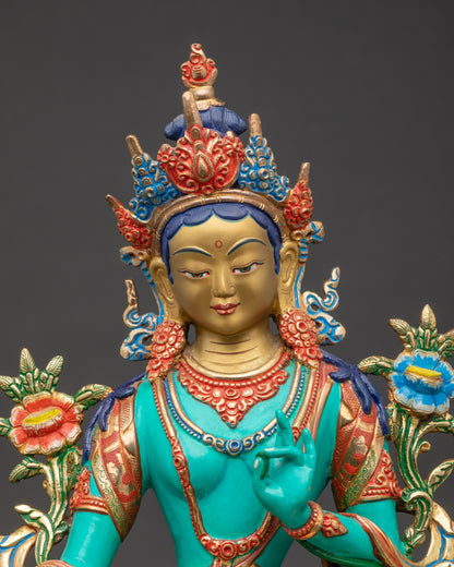 Close up Green Tara face with ornate crown and vibrant gold and jewel-toned details