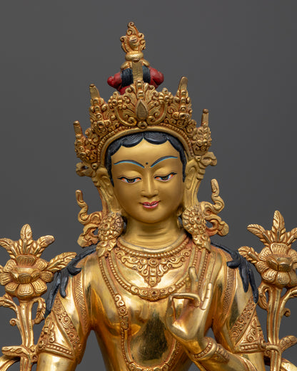 Close up Green Tara gold-painted face with five-jewelled crown and Utpala lotus stem, Himalayan Buddhist art