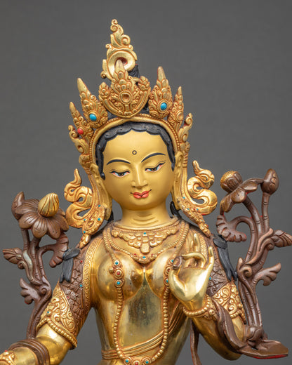 Close up Green Tara statue | Gold-painted face with semi-precious stones and silk garments