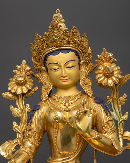 Close up Green Tara statue showing gold fire-gilded surface and floating robe
