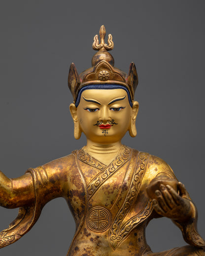 Close up Guru Rinpoche gold-gilded face and lotus hat with wrathful expression