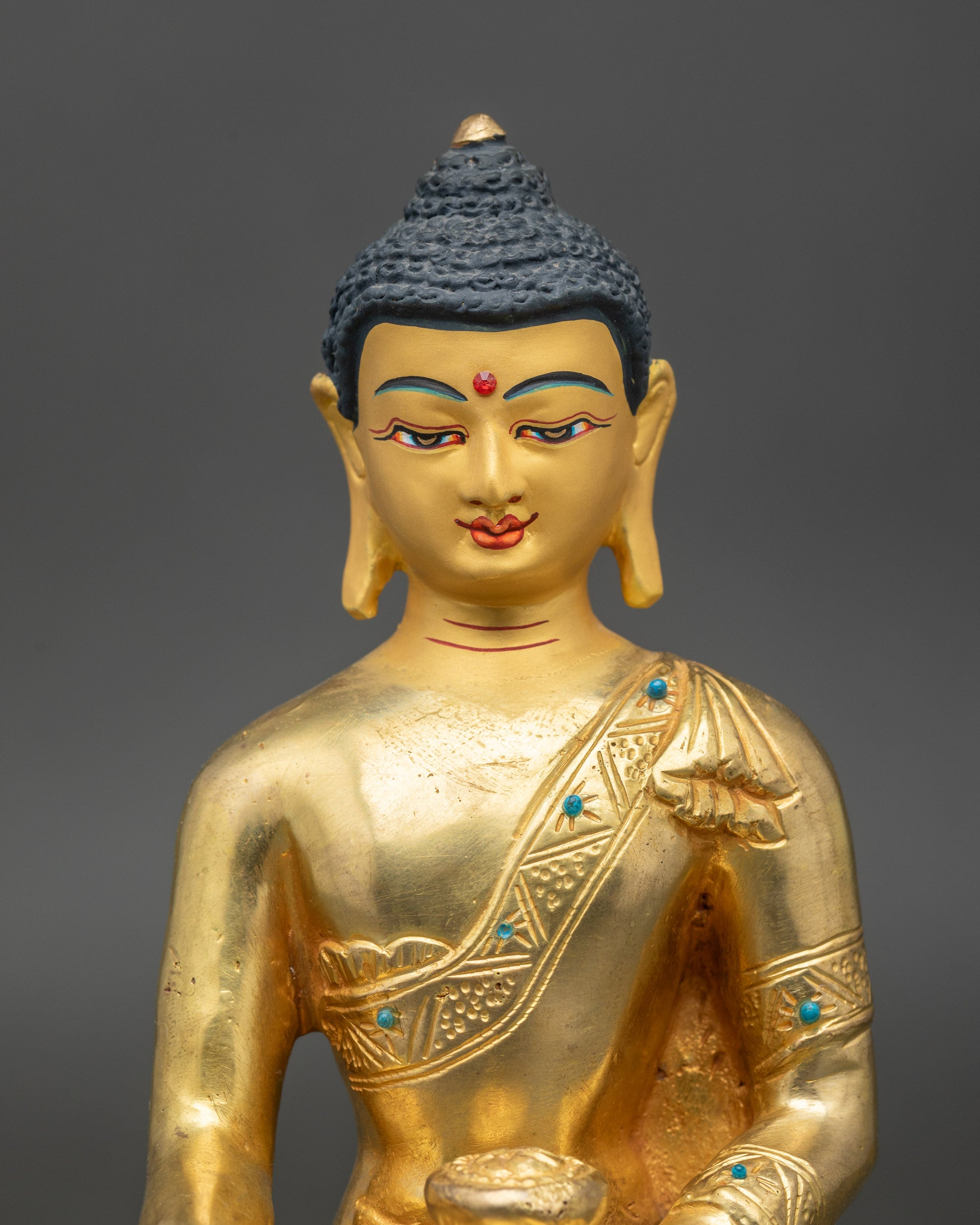 Close up – Handcrafted Newari Shakyamuni Buddha face with gold-painted features, spiritual art
