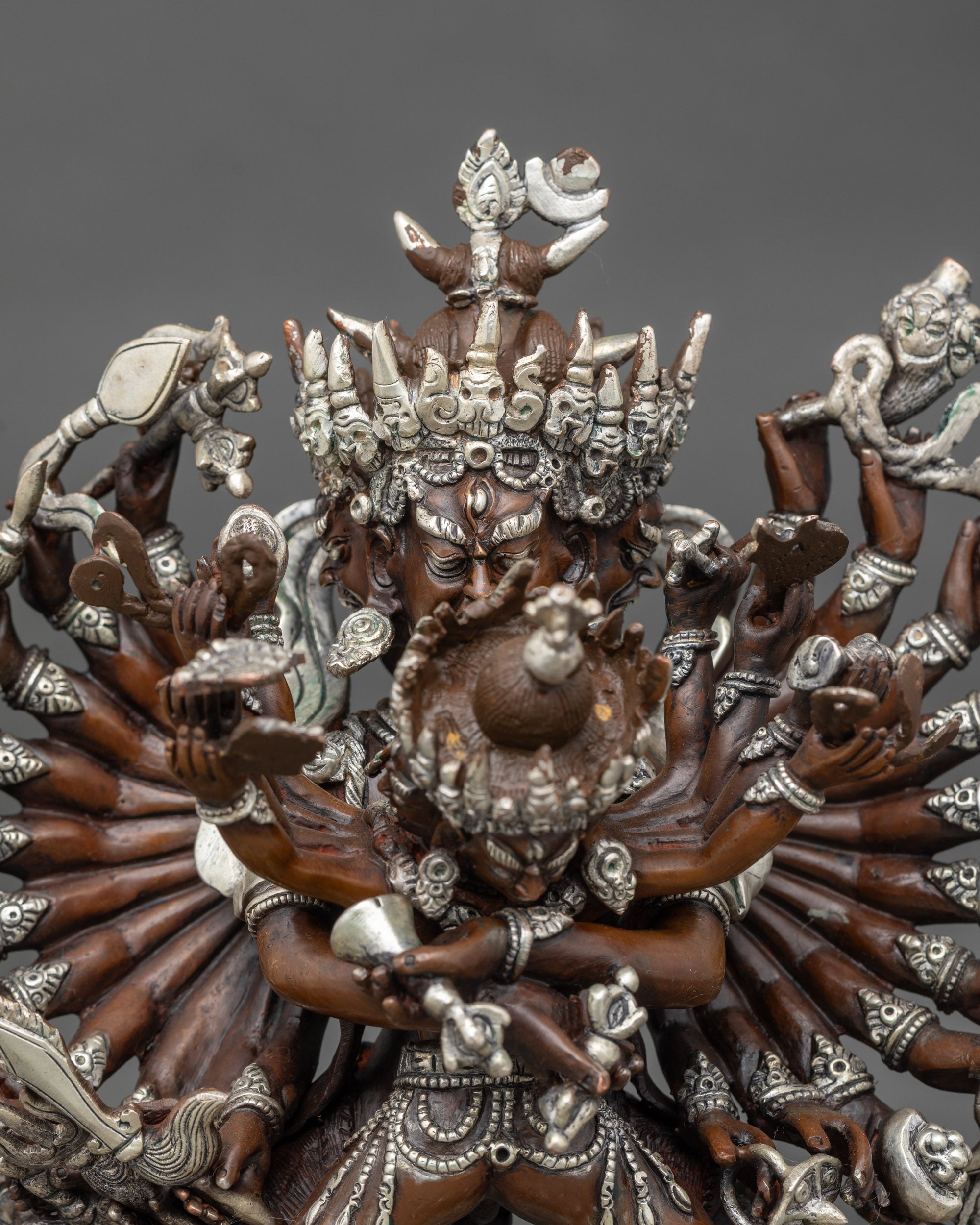 Close up Kalachakra Yab-Yum faces and crown, silver plated copper detail