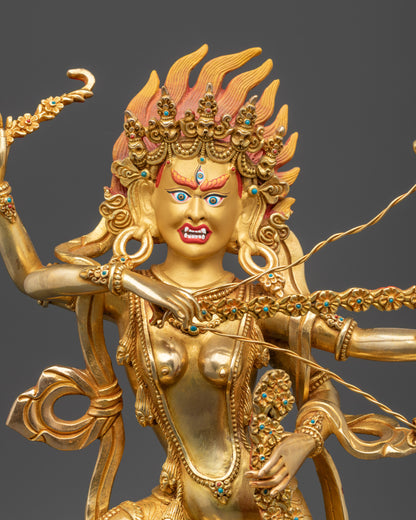 Close up Kurukulla statue showing third eye, bow and arrows, hook, and noose in detail
