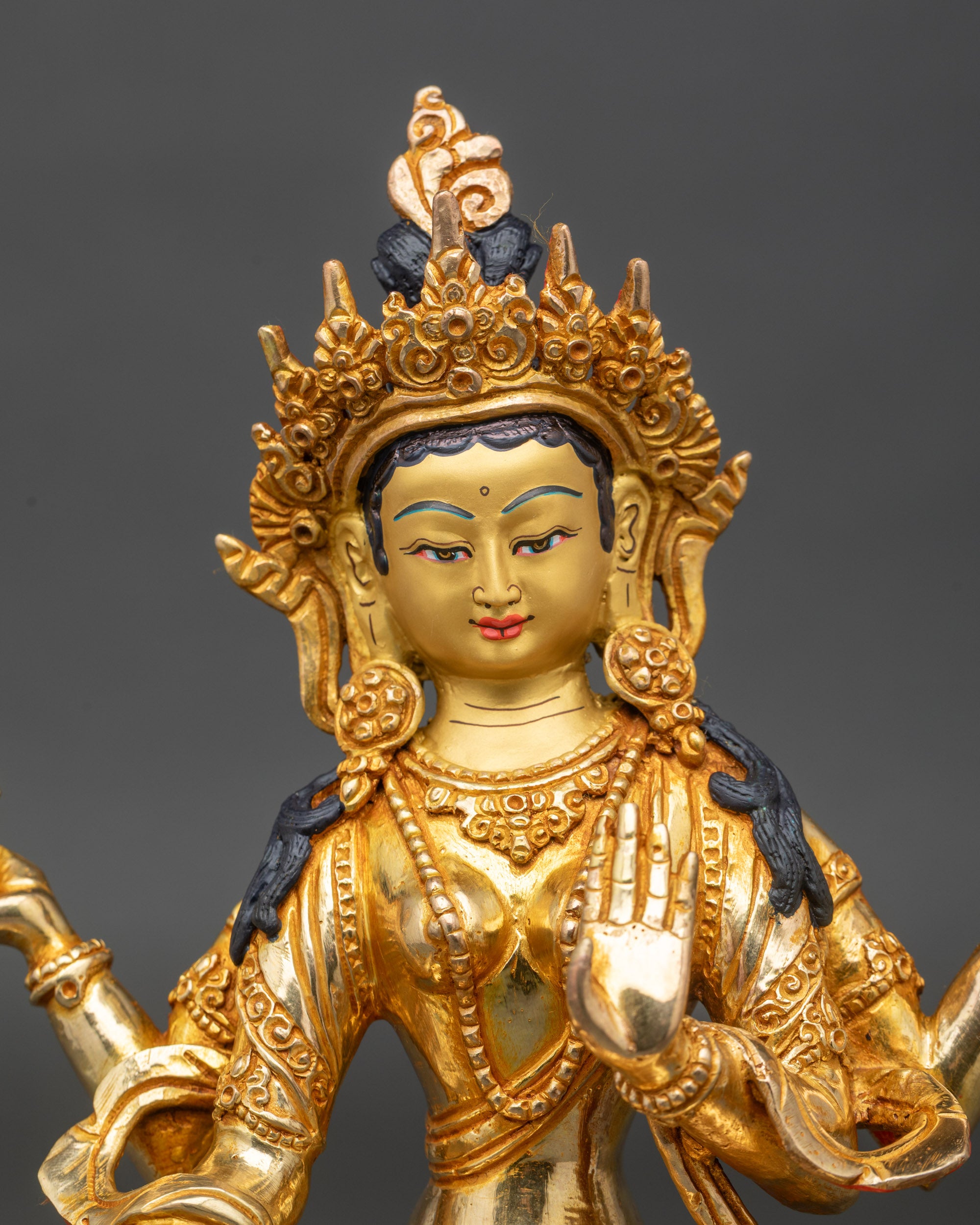 Close up Lakshmi face with serene expression and radiant gold-painted detailing