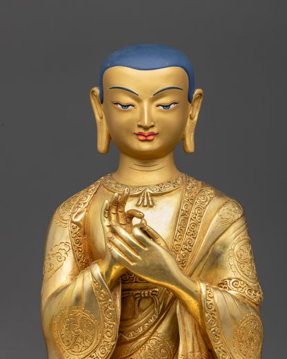 Close up Lama Atisa face with serene divine expression, gold-gilded and detailed carvings
