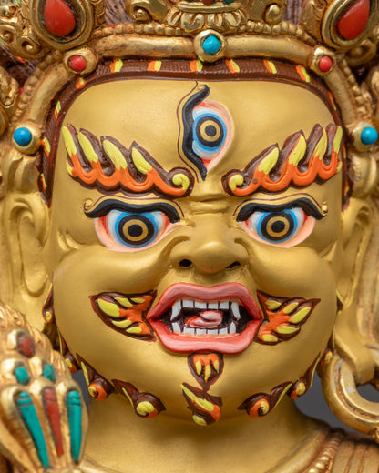 Close up Mahakala gold-gilded face with third eye and skull crown details