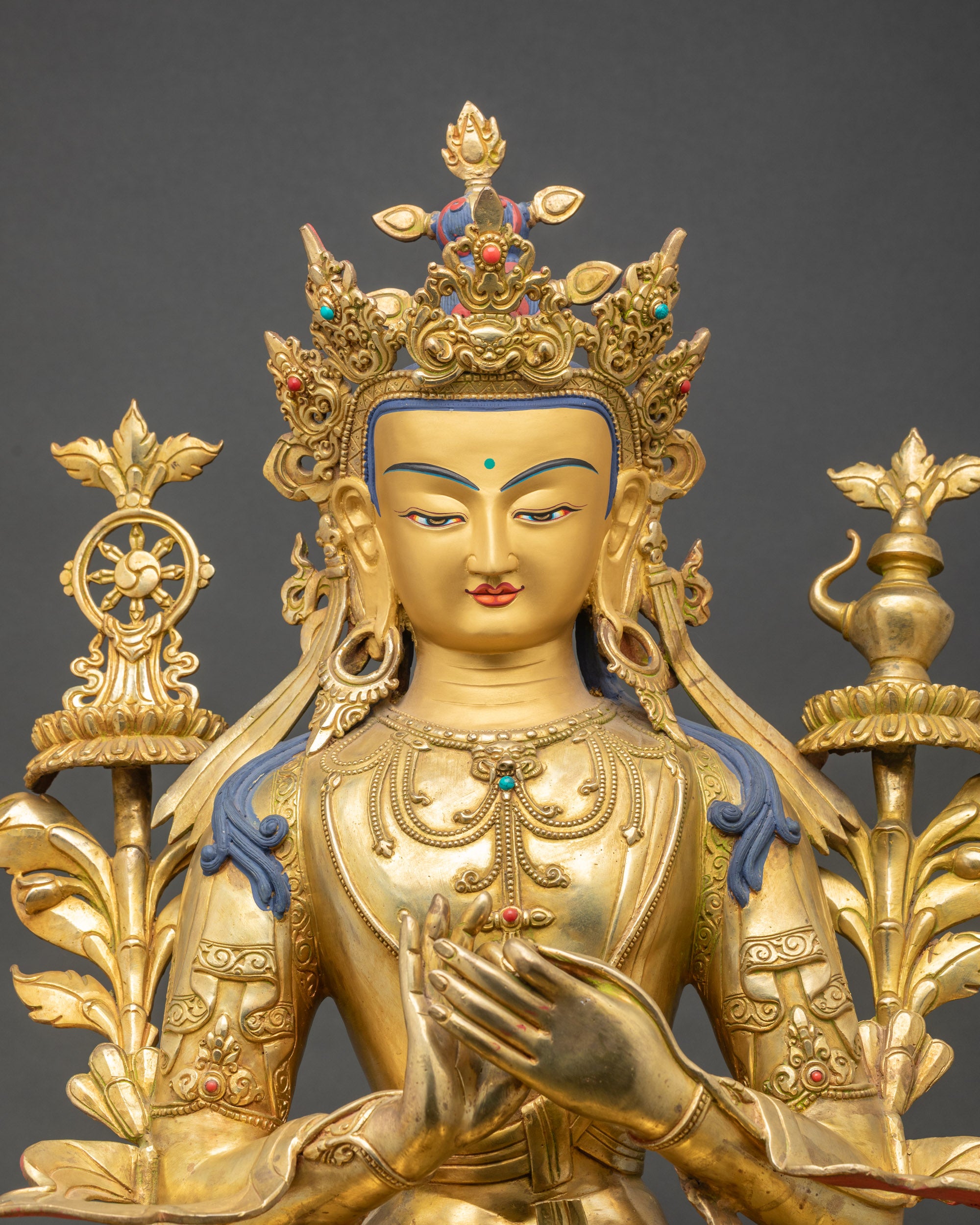 Close up Maitreya Buddha gold painted face with five crown and semi precious stones