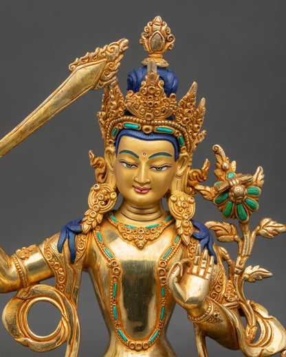 Close up Manjushree face, gold-painted copper, serene gaze, hand-set semi-precious stones