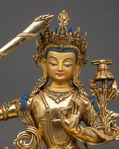 Close up Manjushree face, gold-painted expression with semi-precious stone details
