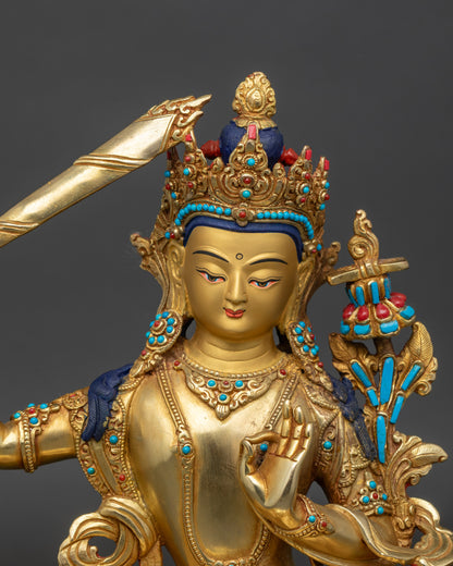Close up Manjushree face with gold-painted features, five-jewel crown and intricate robes