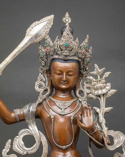 Close up Manjushree statue showing five-jewel crown and semi-precious stone inlays