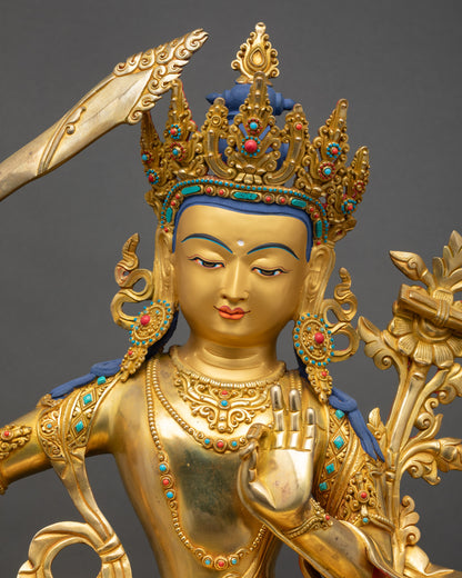 Close up Manjushri gold-painted face with semi-precious stones, Newari craftsmanship