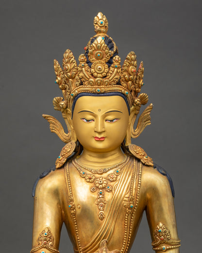 Close up Medicine Buddha gold-painted face with crown, turquoise coral inlay