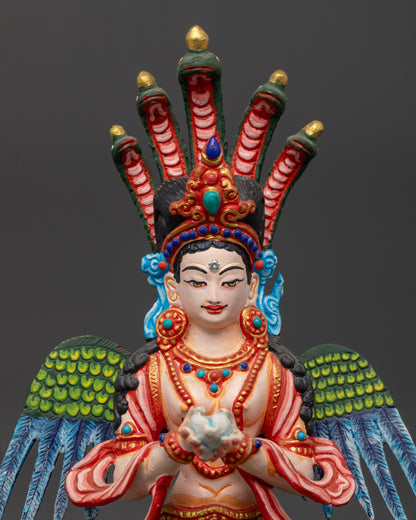 Close up Naga Kanya Statue showing conch shell, semi-precious stones, and fine carvings
