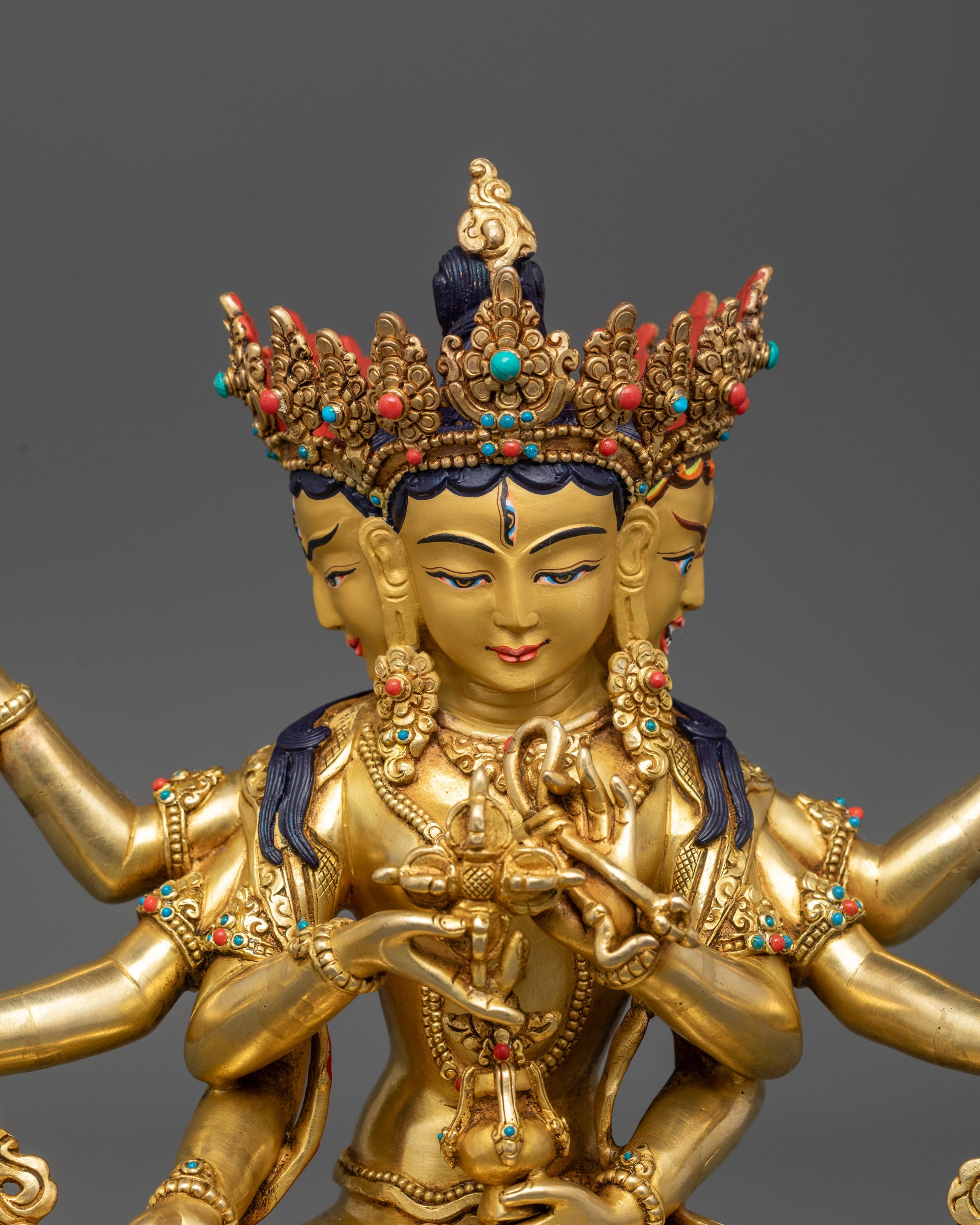 Close up Namgyalma Dakini sculpture showing jeweled crown, armlets, and sacred objects