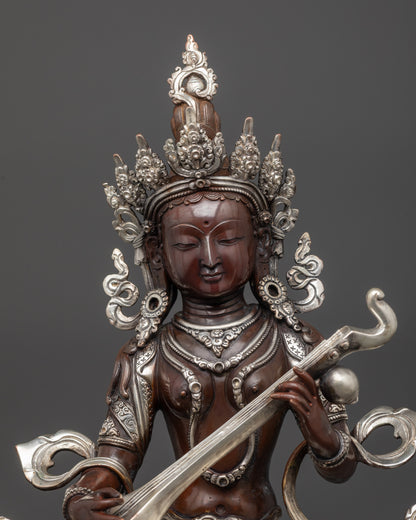 Close up Oxidized Saraswati Statue showing intricate carvings and silver-plated finish