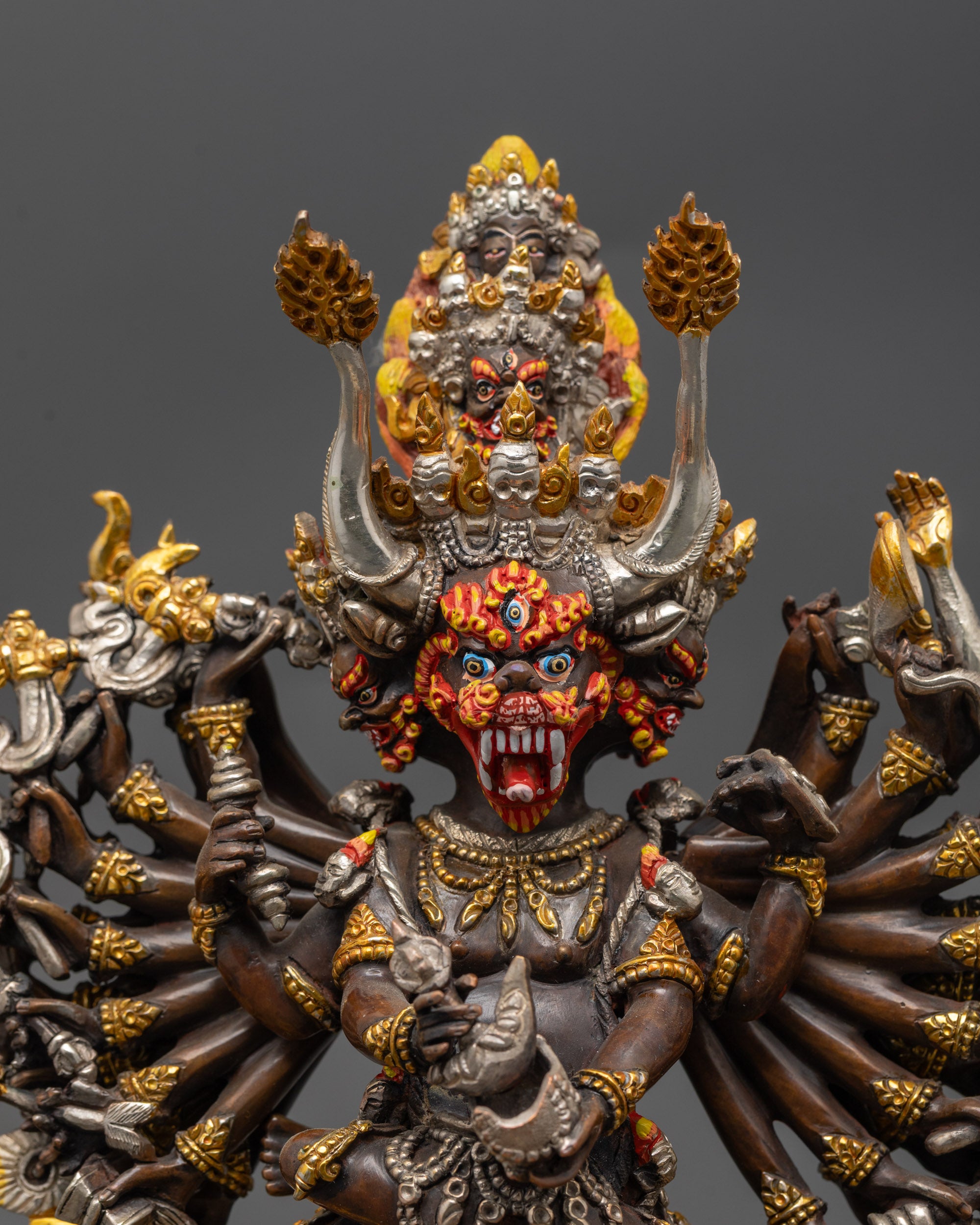 Close up Oxidized Yamantaka holding kartika knife and kapala with skull garland details
