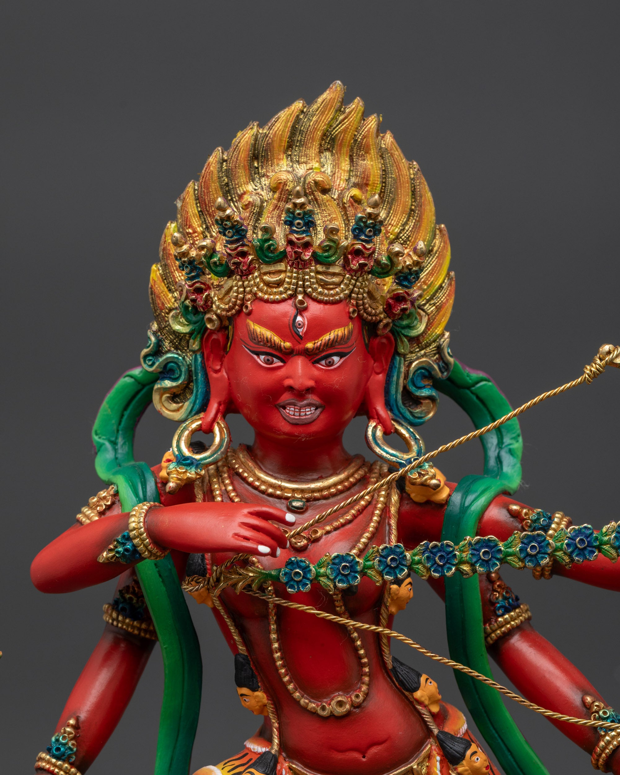 Close up Red Kurukulla copper body with third eye and five-skull crown details