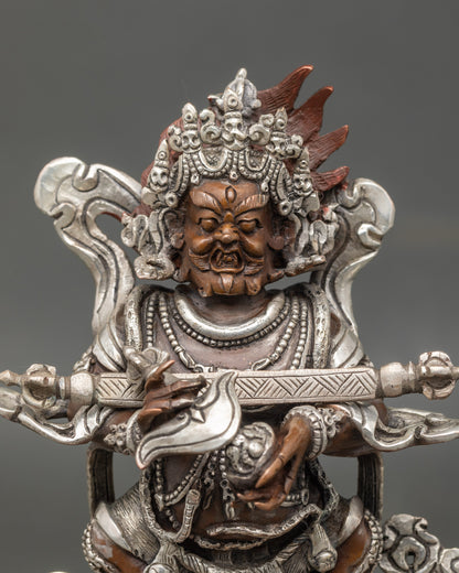 Close up Sakya Mahakala wrathful face with five-skull crown and jewel-adorned ornaments