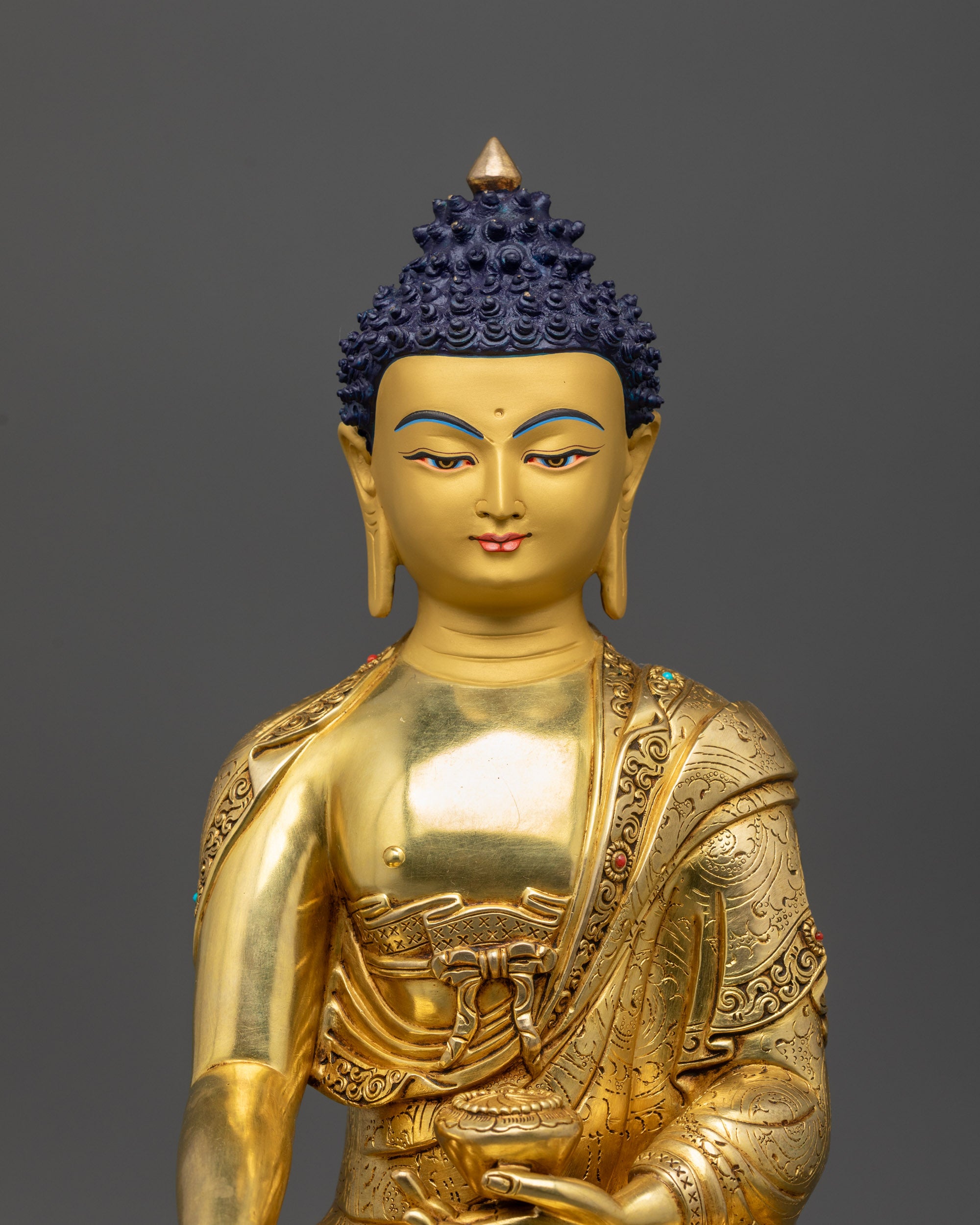 Close up Samana Gotama Buddha intricately carved robe with semi-precious stones
