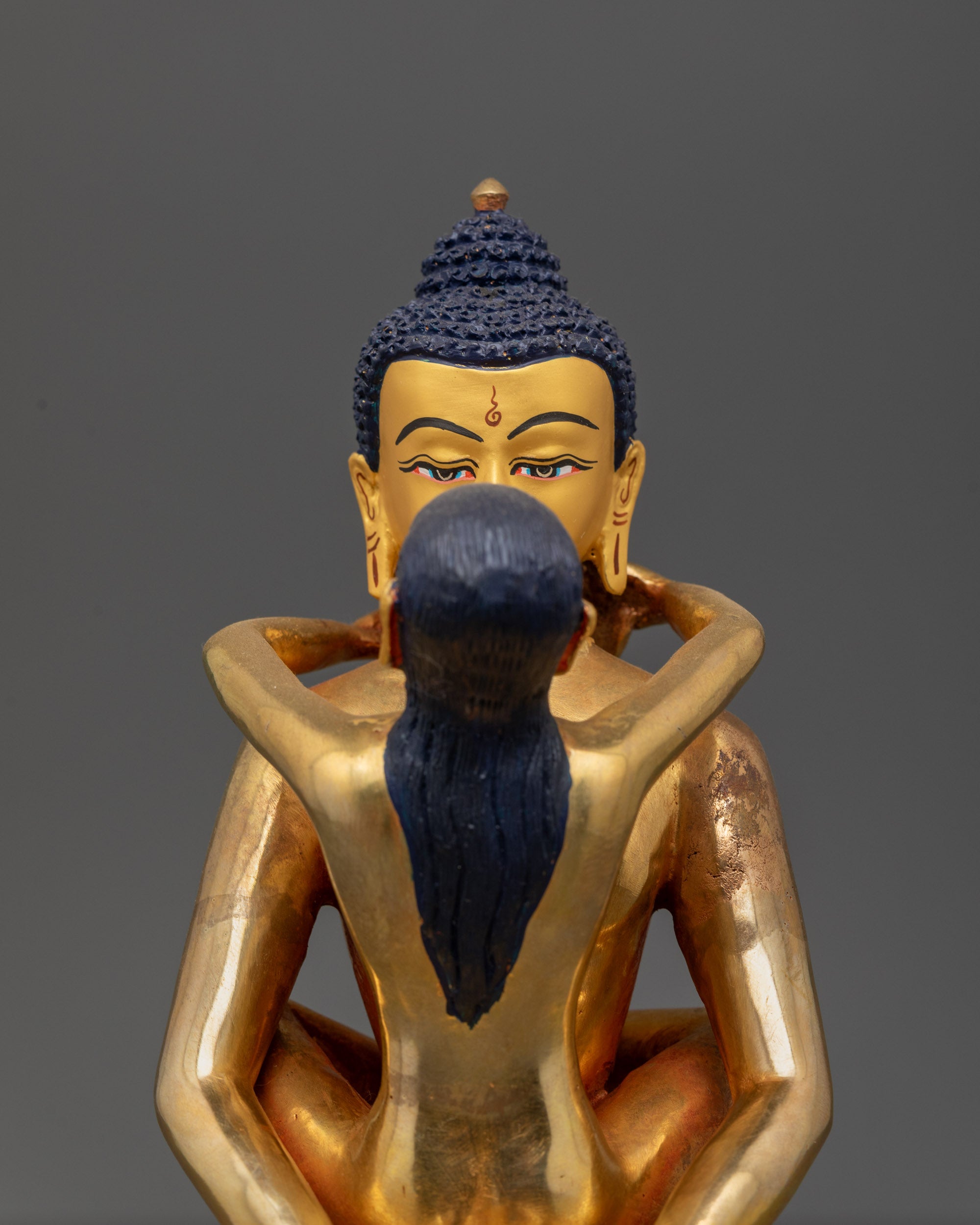Close up Samantabhadri holding kartika knife and kapala with gold-gilded face details

