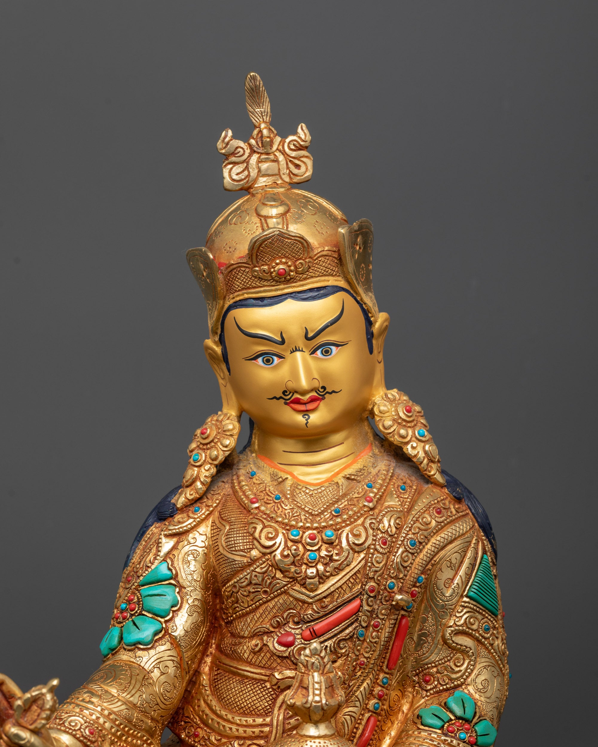 Close up Semi-wrathful Guru Rinpoche Statue with intricate copper body