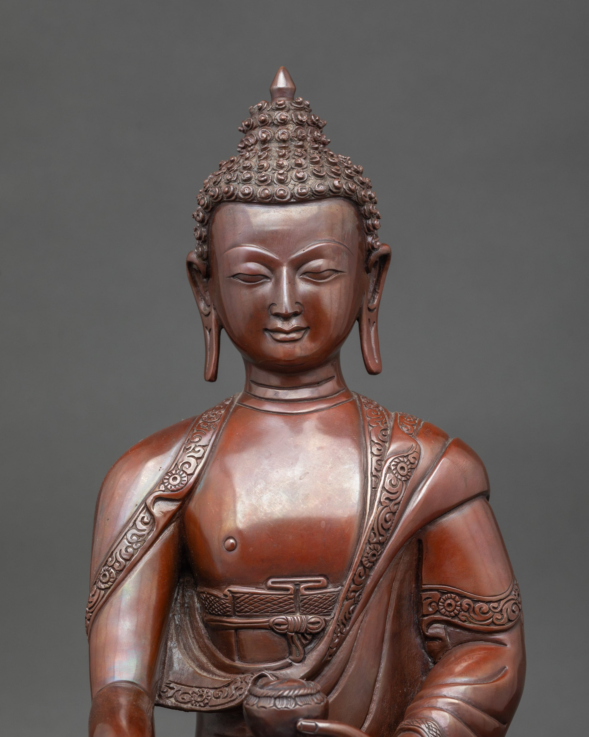 Close up Shakyamuni Buddha face showing serene expression and detailed craftsmanship