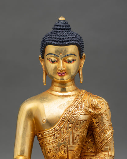 Close up Shakyamuni Buddha gold-painted face intricate robes and serene expression