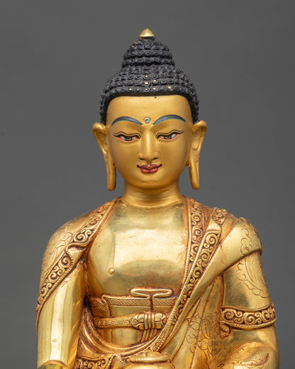 Close up Shakyamuni Buddha gold-painted face intricate robes meditative posture