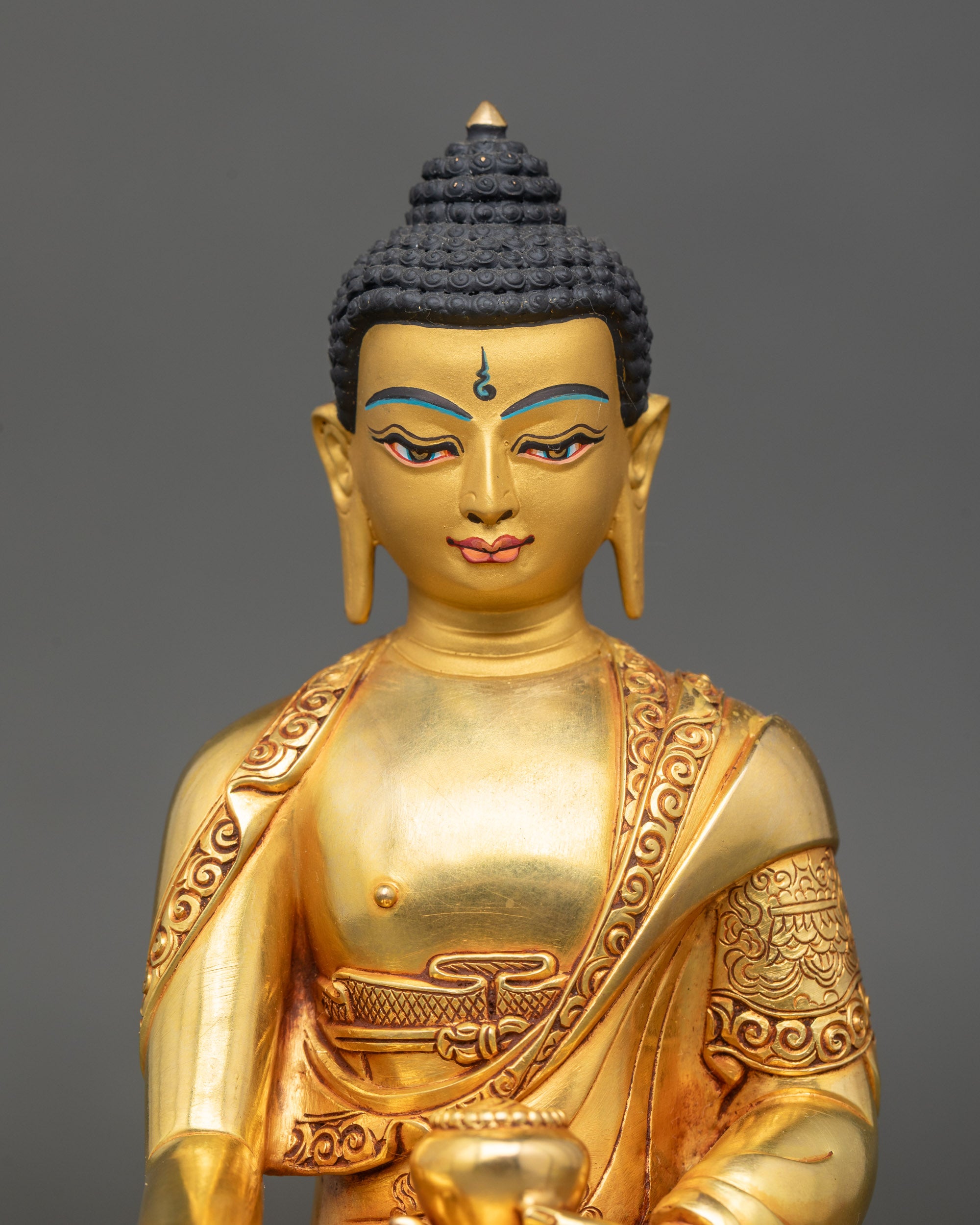 Close up Shakyamuni Buddha gold-painted face lost-wax Nepalese craftsmanship