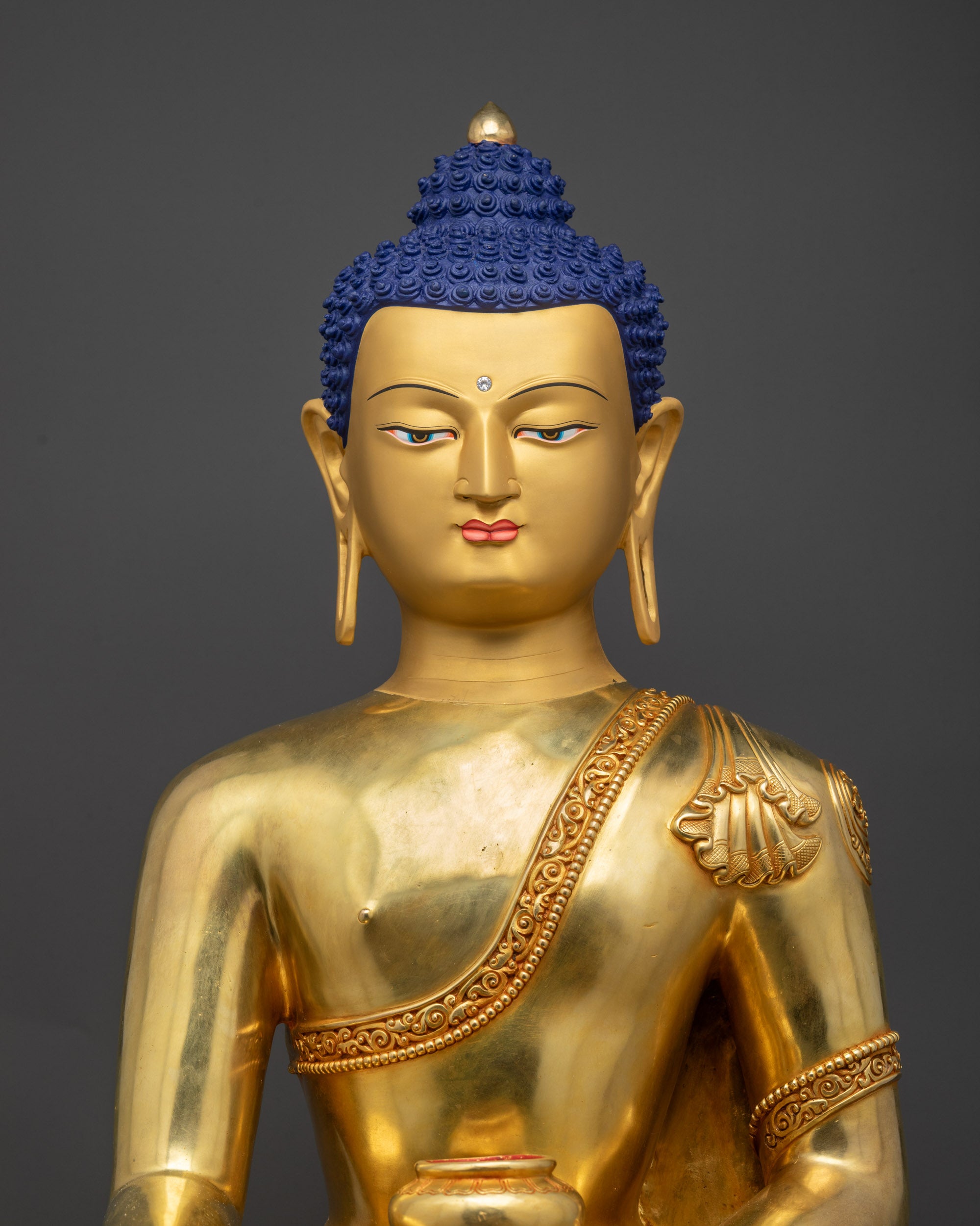 Close up Shakyamuni Buddha serene face with gold-gilded details for spiritual focus
