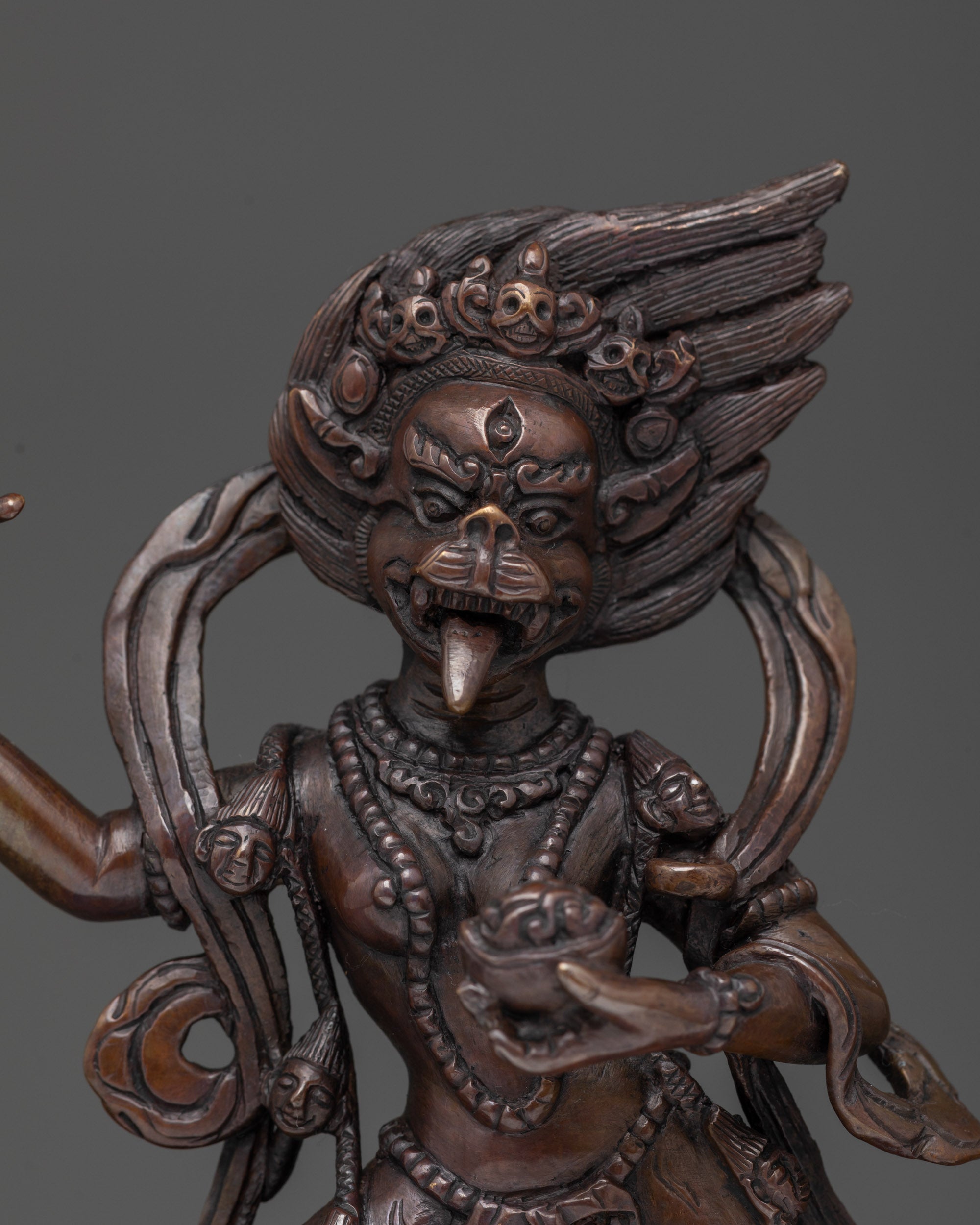 detailed lion-faced copper figurine