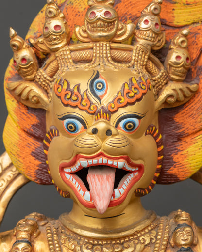 Close up Simhamukha statue showing gold-gilded face, skull crown, and intricate details