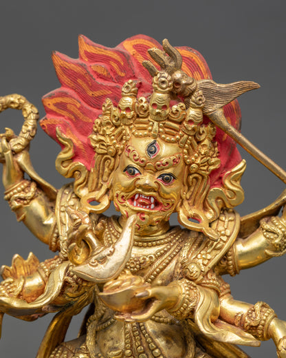 Close up Six-Armed Mahakala gold-painted face with wrathful expression and third eye