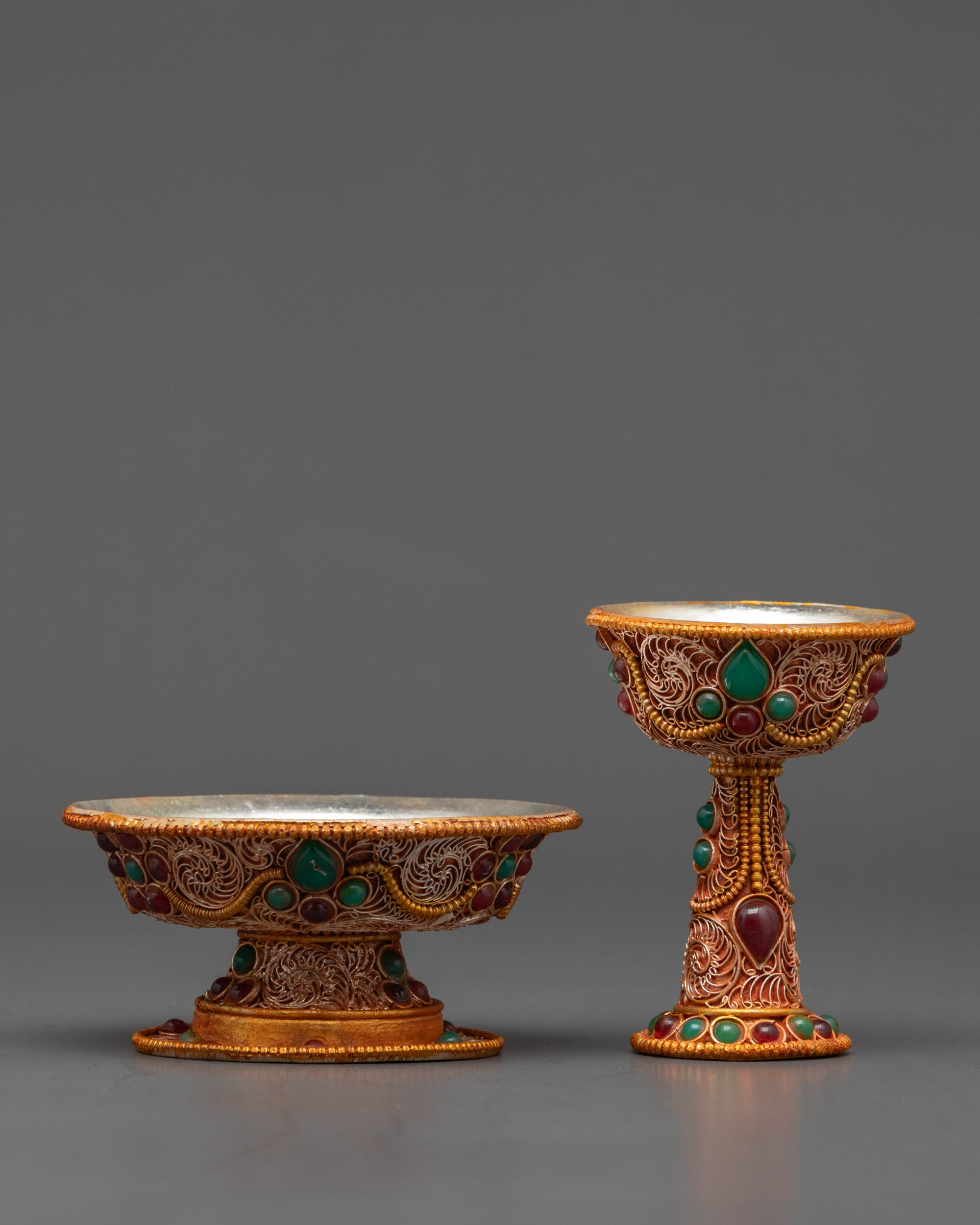 Close up Tibetan Serkyem Bowl showing emerald and ruby gemstone patterns
