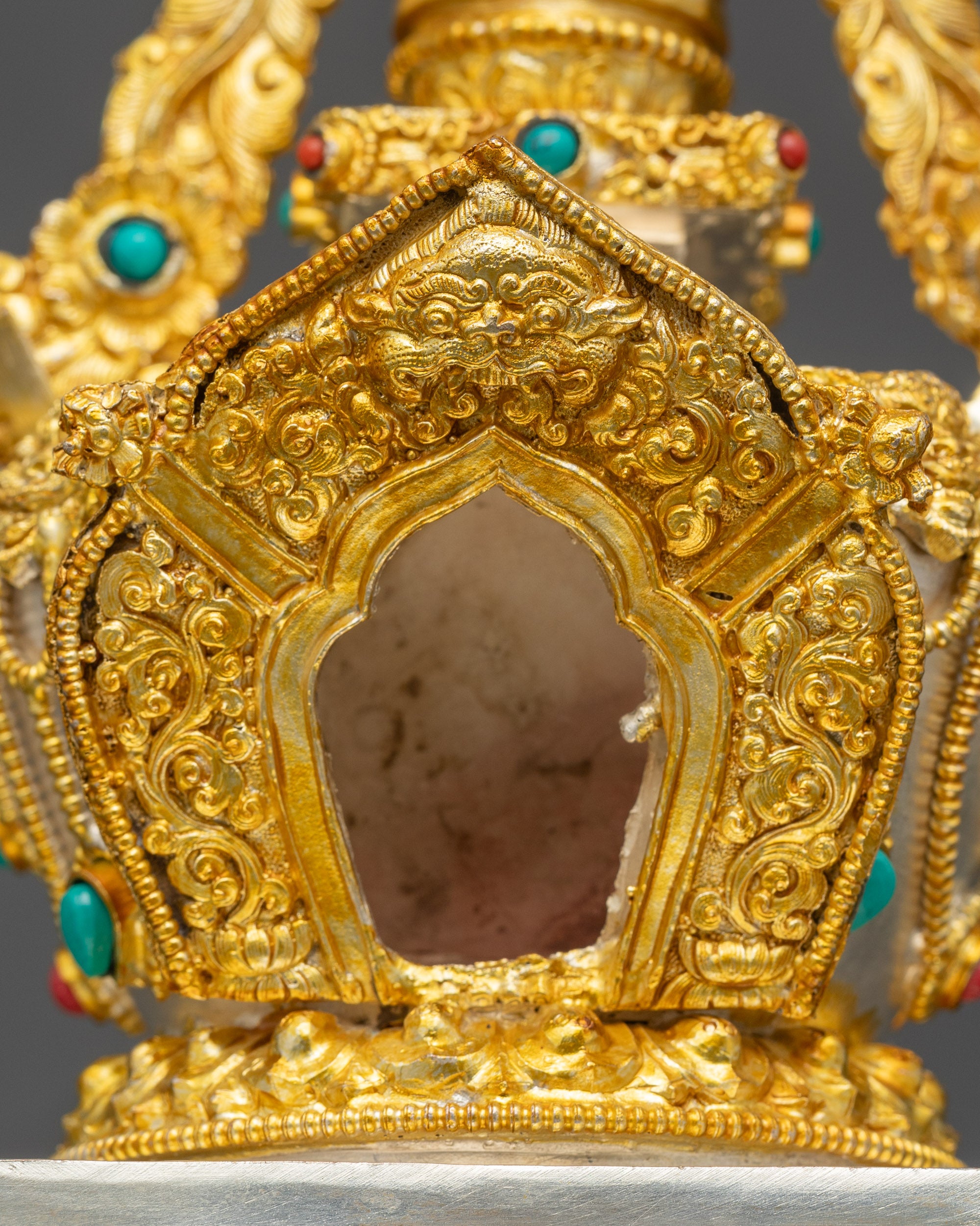 Close up Tibetan Stupa vishwa vajra filigree gold silver finish sacred stone details
