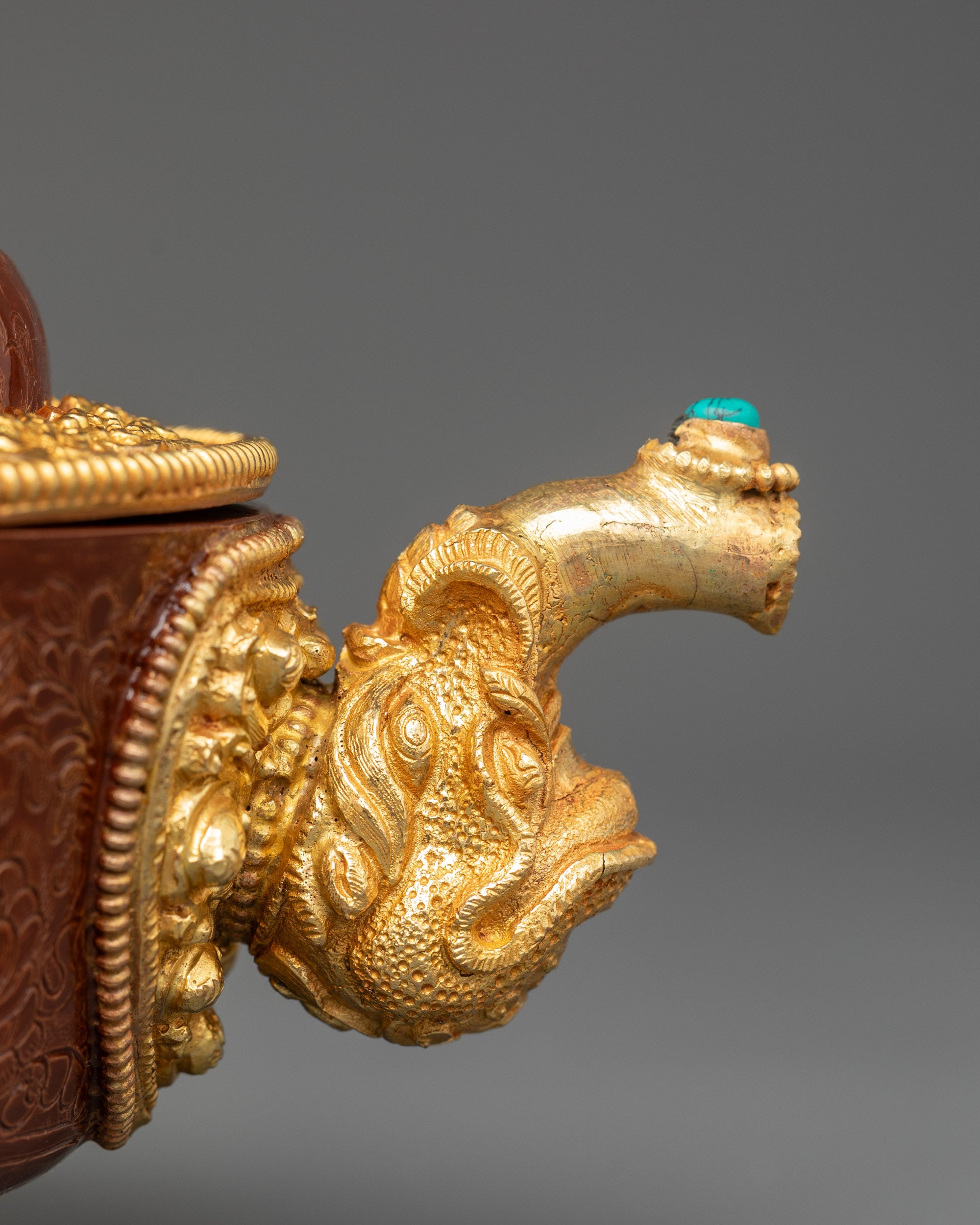 Close up Tibetan Torjang teapot with dragon-head spout and gold-plated copper body