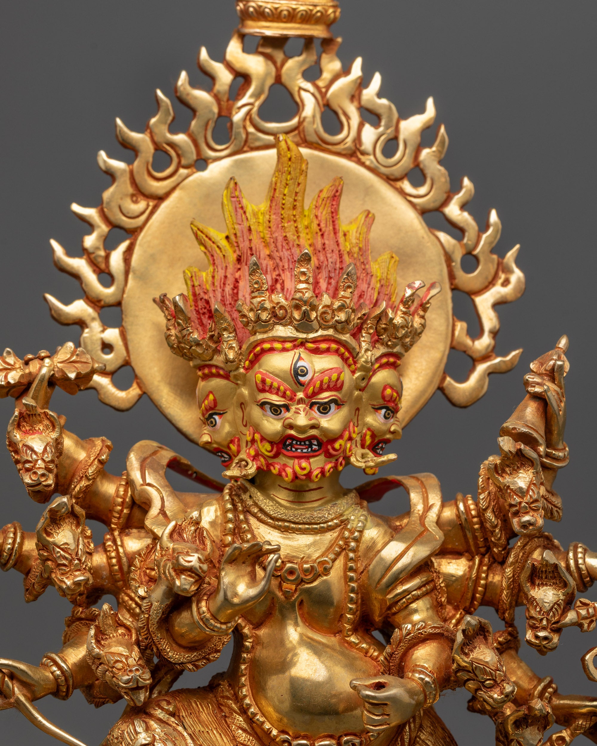Close up Ucchusma Statue showing wrathful expression and gold fire-gilded body details
