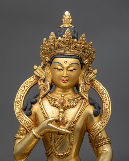 Close up Vajrāsattva Buddha face, gold-painted with detailed crown and intricate jewelry