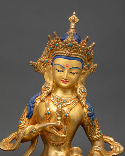 Close up Vajrasattva holding vajra and bell adorned with semi-precious stones
