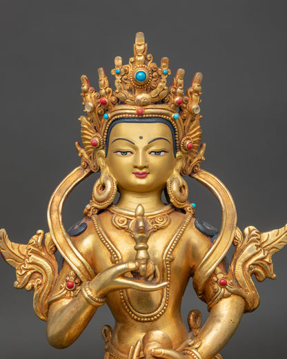 Close up Vajrasattva statue, gold-painted face adorned with semi-precious stones