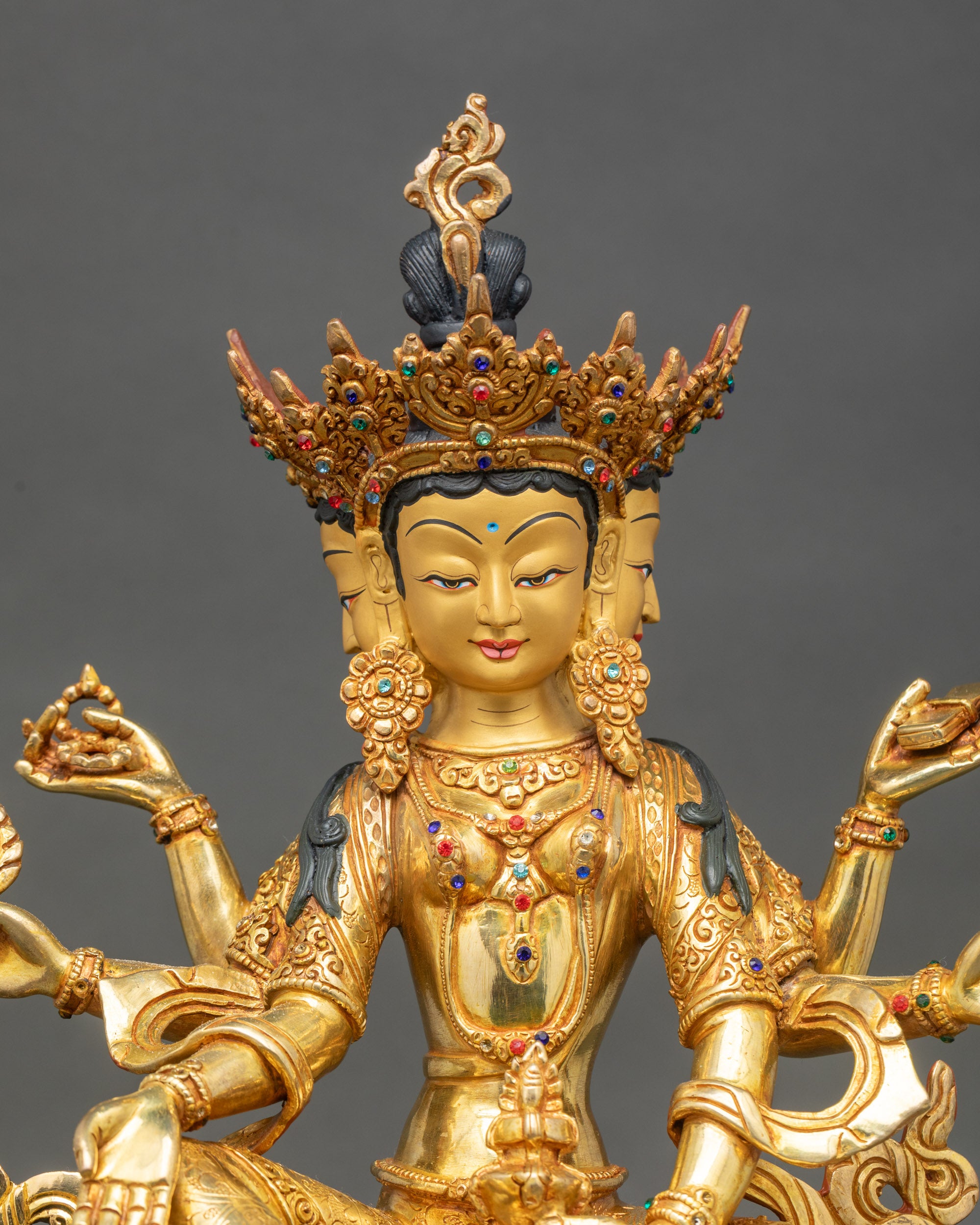 Close up Vasudhara Buddha gold-painted face copper sculpture Newari artisan handcrafted Patan Nepal