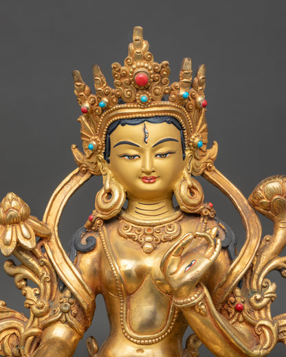 Close up White Tara face, gold-painted, adorned with semi-precious stones, Newari craftsmanship