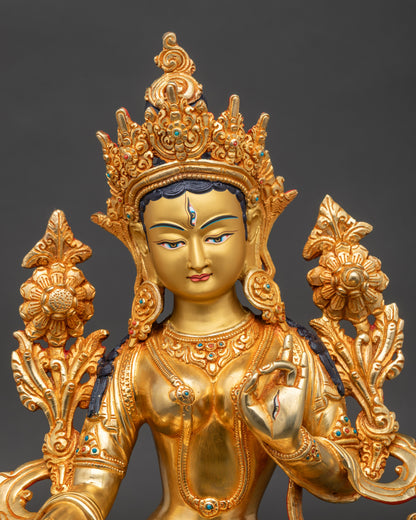 Close-up White Tara gold-painted face, seven eyes, a semi-precious stone, and Newari craftsmanship