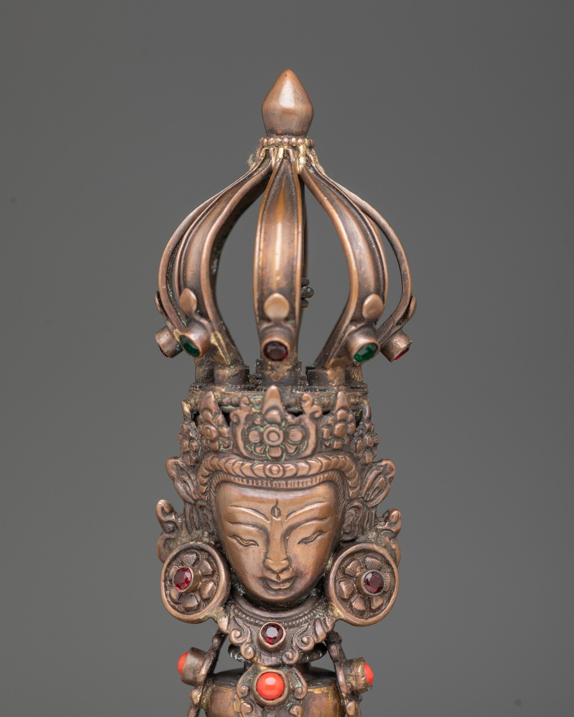 Close up bronze bell handle with five jeweled crown deity, oxidized copper Vajra for meditation
