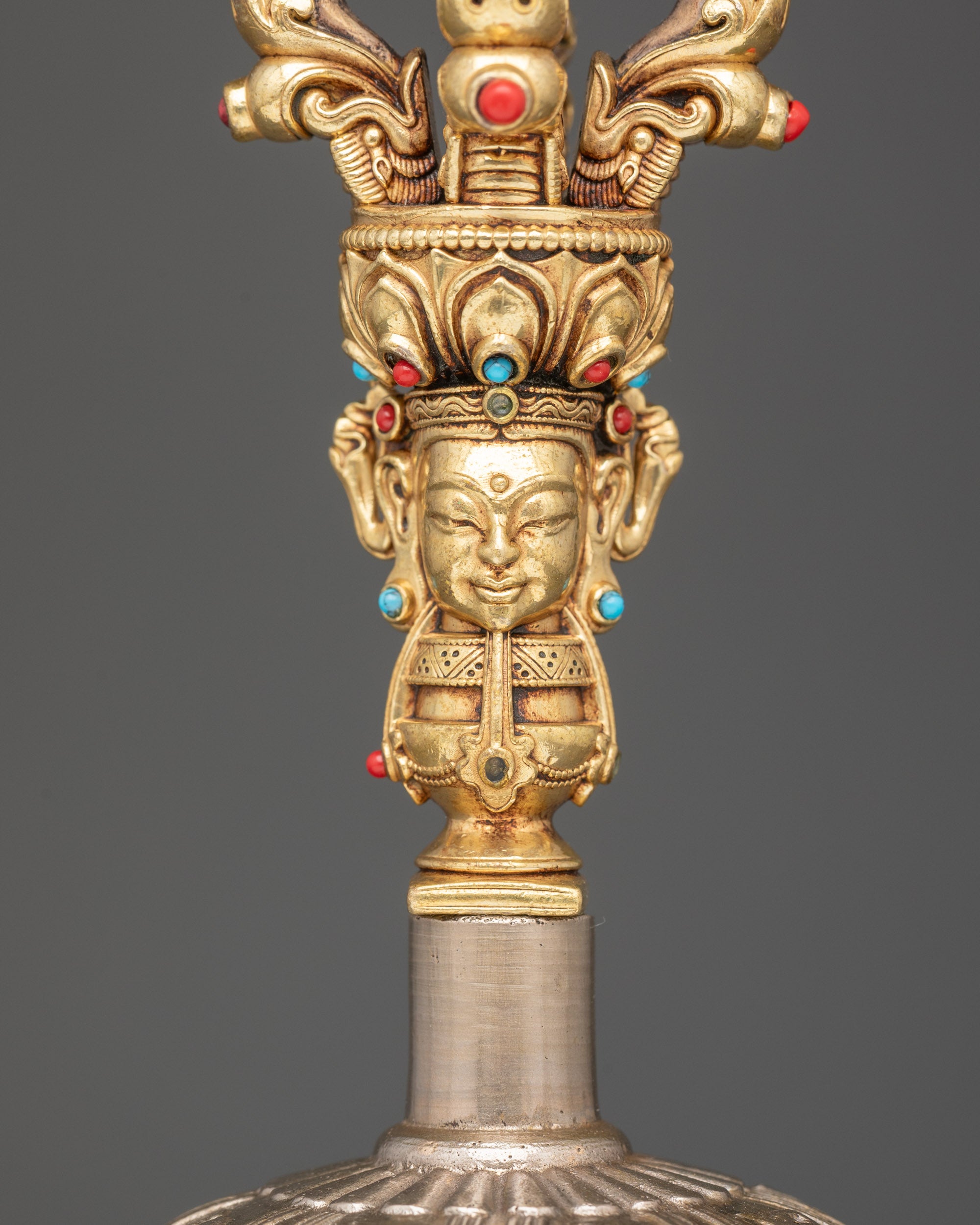 Close up bronze bell with copper handle carved deity for meditation rituals