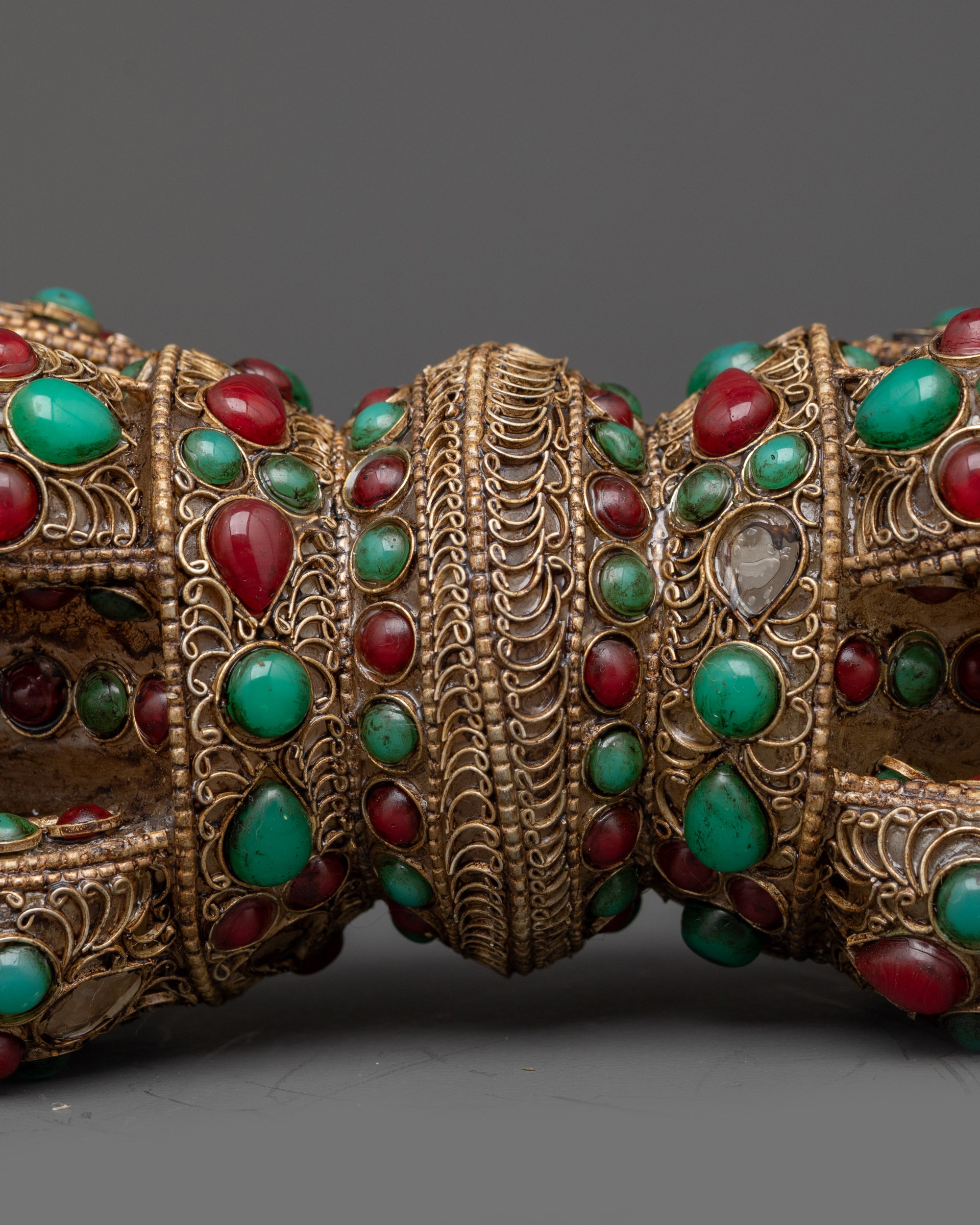 Close up copper Dorje with turquoise, coral, and crystal core